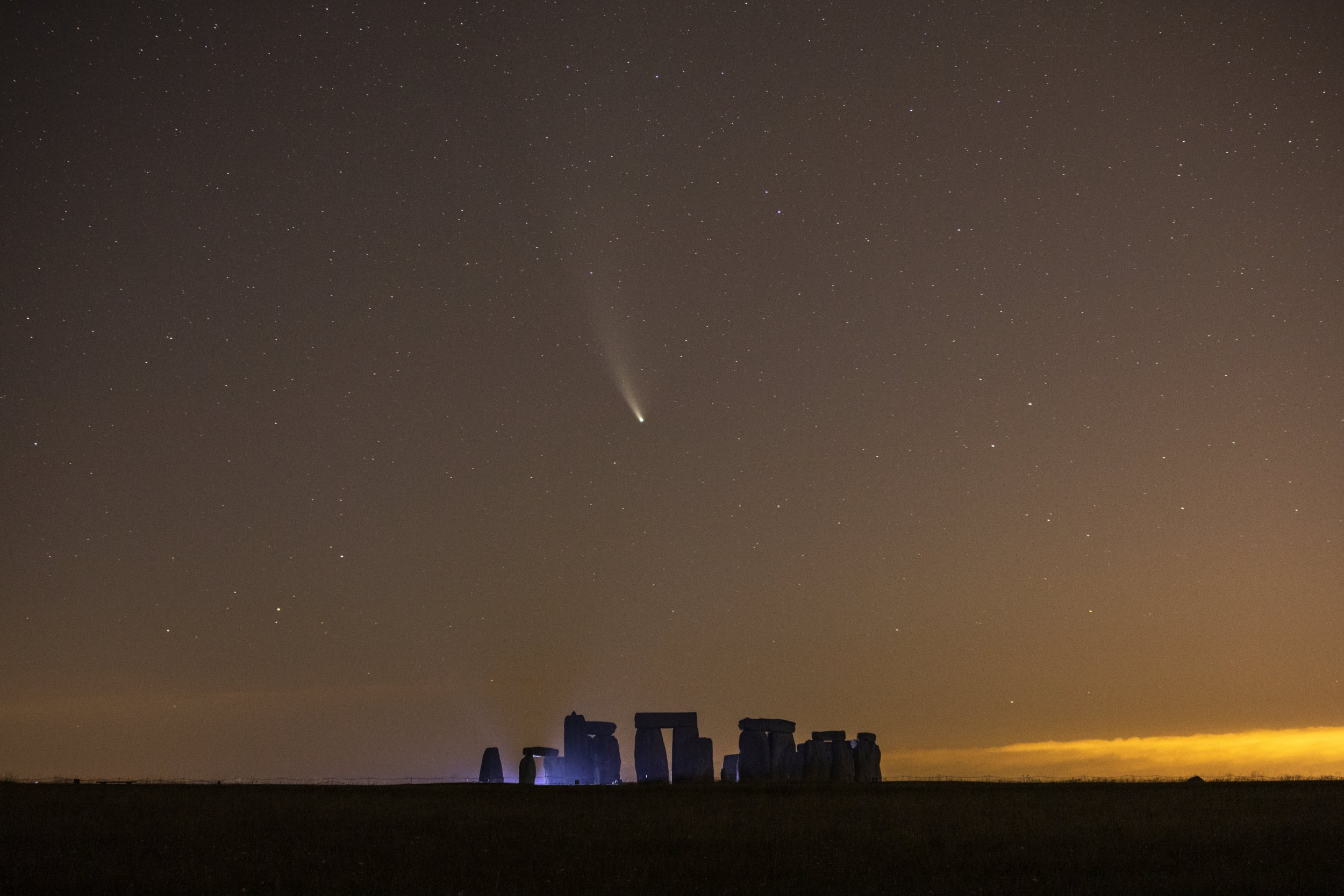 European Best Pictures Of The Day - July 21 - SALISBURY, ENGLAND - JULY 21: Comet NEOWISE passes over Stonehenge in the early hours of July 21, 2020 in Salisbury, England. Comet NEOWISE, the brightest seen in the Northern Hemisphere in 25 years, was discovered by Nasas Near-Earth Object Wide-field Infrared Survey Explorer (NEOWISE) mission on March 27. The comet is currently visible after sunset and will have its closest encounter with Earth on July 23 when it will be around 64 million miles away. (Photo by Dan Kitwood/Getty Images)