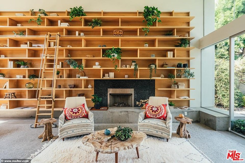 A better look: There is plenty of space for parties with a wide fireplace for cozy evenings and built-in light wood bookshelves to store her favorite page turners as well as knickknacks