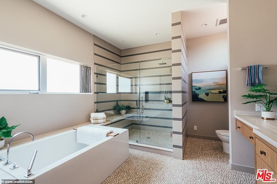 Great for a long and relaxing spa day: A bathroom is attached and offers a rectangular bathtub with a steam shower