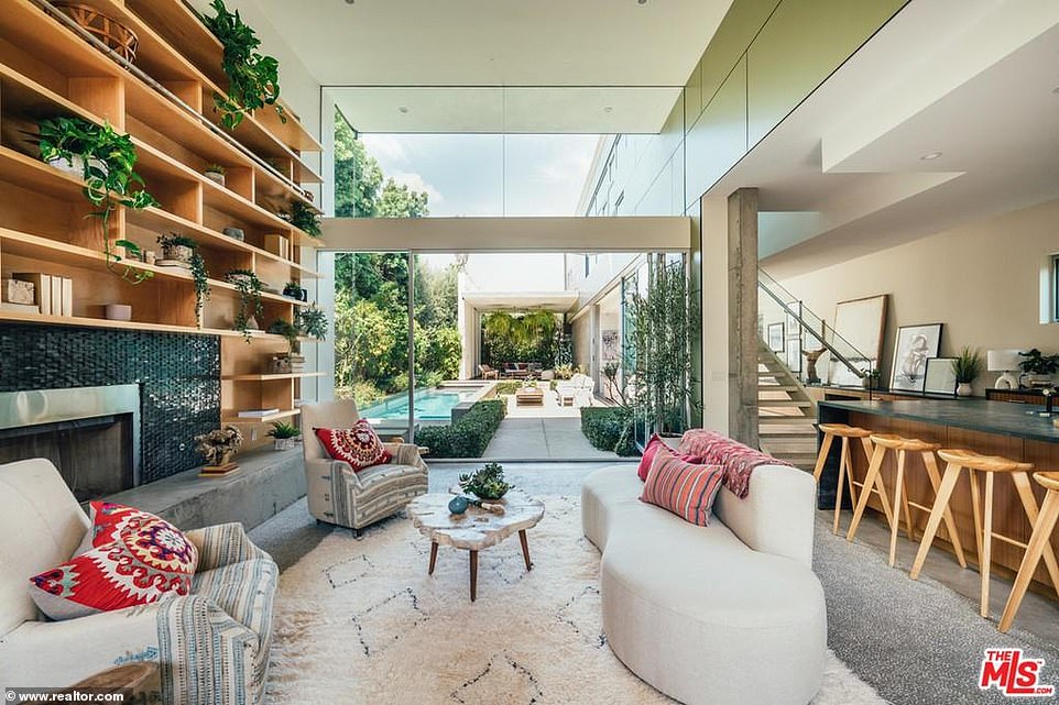 Party zone: The best room in the house is the oversized living room with 15-foot ceilings and a glass wall that looks out to the back yard