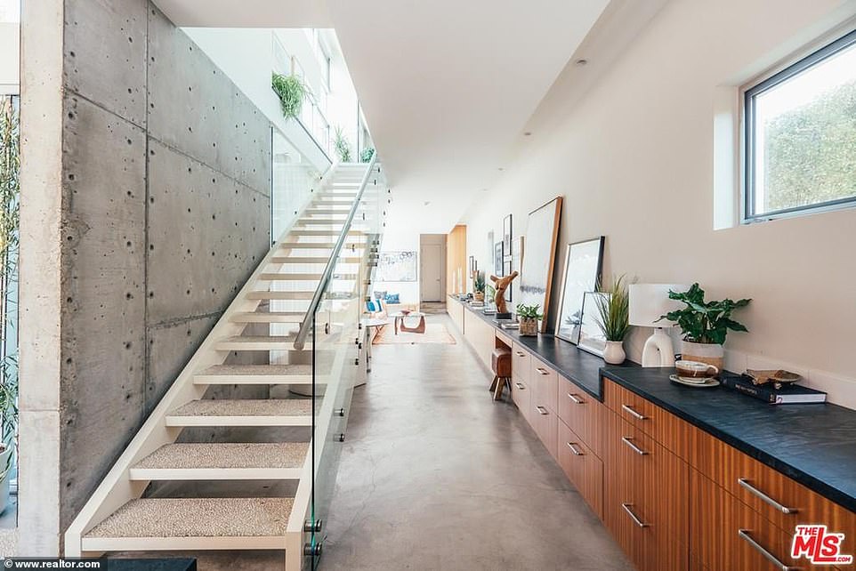 Can't be missed: There is a long staircase that commands attention with a 'floating' feel as there is open between the steps and a glass wall to prevent falls