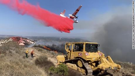 The bulldozer extinguished the blaze as a Calfire plane dropped a foss-check near a 110-acre fire at Vandenberg Air Force Base.