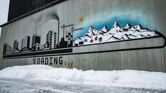 New graffiti depicts buildings and chimneys instead of the island's natural landscape