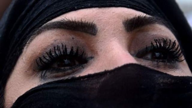 woman with colored eyes and burqa