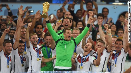 Germany keeper Neuer  lifts the World Cup trophy with his team after defeating Argentina 1-0 in the 2014 World Cup final.