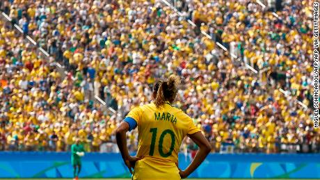 Brazil&#39;s player Marta stands facing the Brazilian crowd.