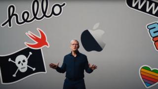 Tim Cook is seen against a backdrop