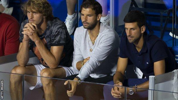 Grigor Dmitrov seated next to Novak Djokovic