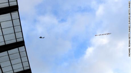 A plane flies over the Etihad Stadium with a banner reading &quot;White Lives Matter Burnley.&quot;  