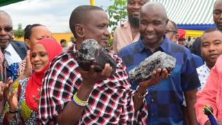 Saniniu Laizer carring the gemstones at the trading centre
