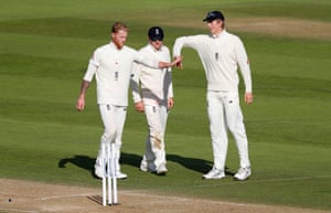 Ben Stokes of England celebrates with Dom Bess and Zak Crawley after taking the wicket of Alzarri Joseph.