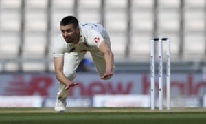 England’s Mark Wood falls on the ground after bowling a delivery.