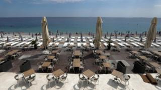 Tables and deckchairs are set out to respect social distancing on the Promenade des Anglais beach in Nice
