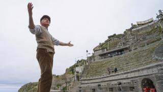 Actor Mark Harandon rehearsing alone at the open air Minack Theatre in Cornwall