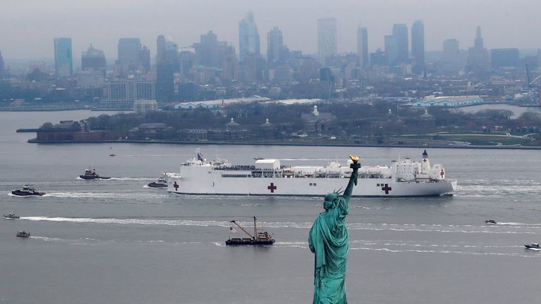 The USNS Comfort passes the Statue of Liberty as it enters New York Harbour during the outbreak of the coronavirus disease (COVID-19)