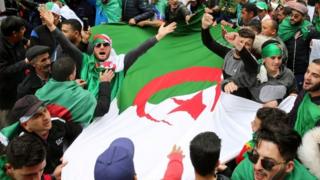 People carry Algeria's national flag in Algiers. File photo