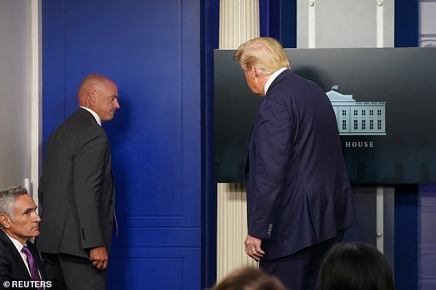 The agent escorted President Trump from the briefing room
