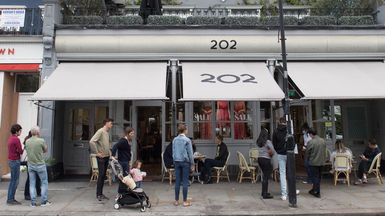 People queue at a restaurant in Notting Hill on the last day of the Eat Out to Help Out initiative