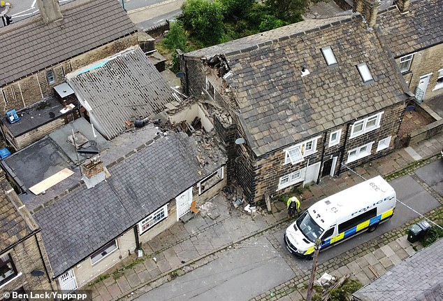 A 47-year-old man has died and a 28-year-old woman has been injured after their neighbour's chimney fell onto their house in Knight's Fold, Bradford, at 5.06am