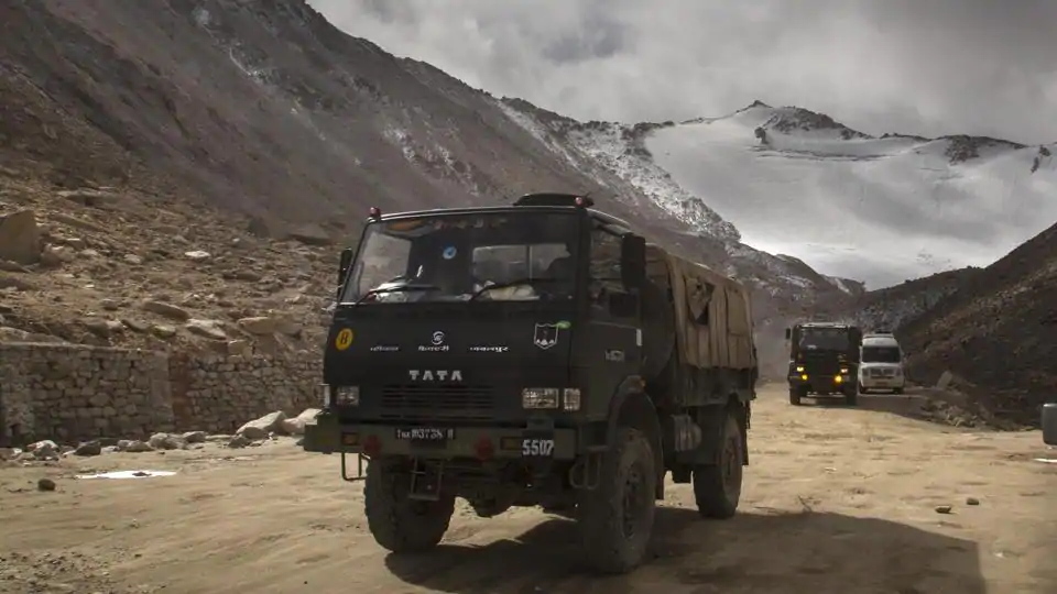 Indian Army vehicles drive on a road in Ladakh region near the border with China