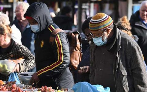 Shoppers wear facemasks at Leeds City Markets in Leeds, Yorkshire on October 31, 2020, as the number of cases of the novel coronavirus rises.