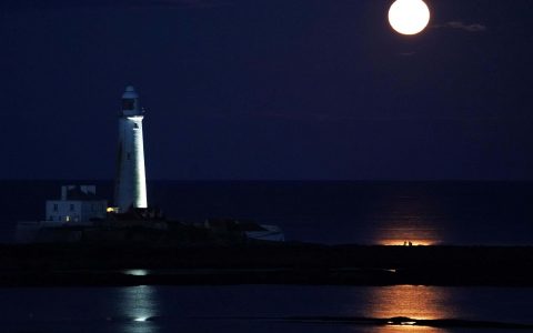 The August Full Moon, known as the  Sturgeon Moon, rises above St Mary's Lighthouse in Whitley Bay