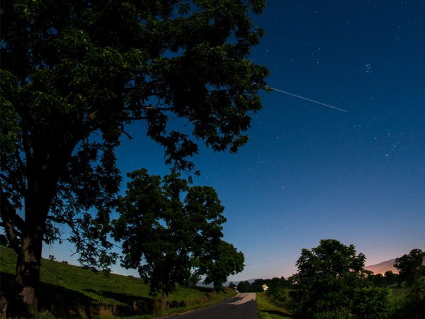 The International Space Station is seen in this 30-second exposure as it flies over Elkton, VA in the morning, Saturday, August 1, 2015. 