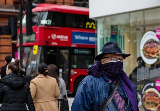 A man with a face mask and scarf walks on Oxford Street amidst an outbreak of coronavirus in London, England (Photo: Getting Images)