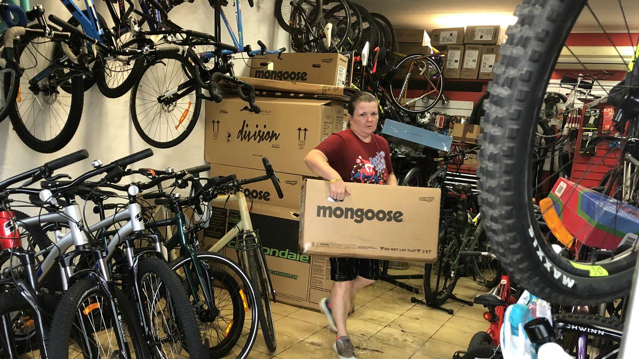 Flash Flood: Rachel Sipple, co-owner of Bus Ride Bicycles, picks up a bicycle away from floodwaters at her Viralla RD, East Lizmore store.  Photo: Allison Patterson