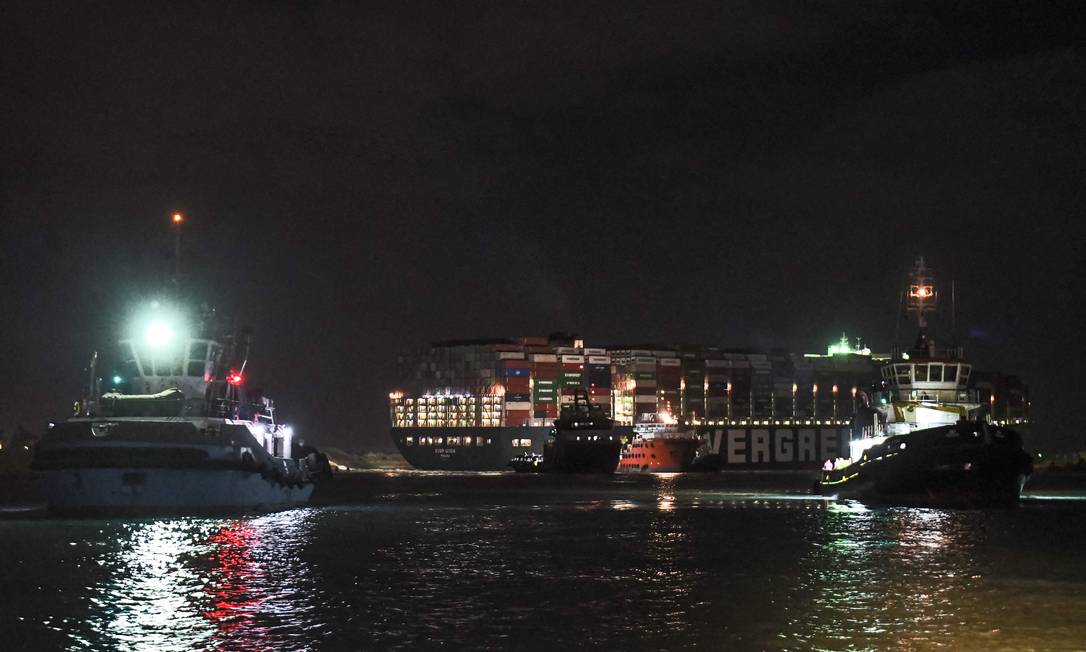 Tugboats worked to land the giant Ever Given Photo on Saturday night: Ahmed Hassan / AFP