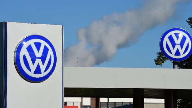 The logo of German automaker Volkswagen is seen at a factory in Germany, with smoke in the background (Photo: Getty Images/Archive)