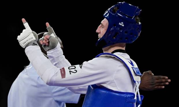 Bradley Sinden (blue) of Great Britain celebrates victory against Chinese Zhao Shuai in the men's 68kg taekwondo semifinal Photo: Javier Soriano / AFP