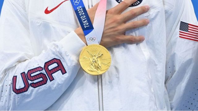 American athlete photographed with gold medal