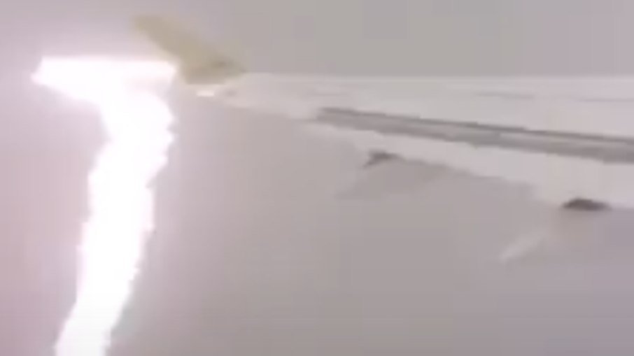 The plane is struck by lightning and the passenger captures the moment of impact