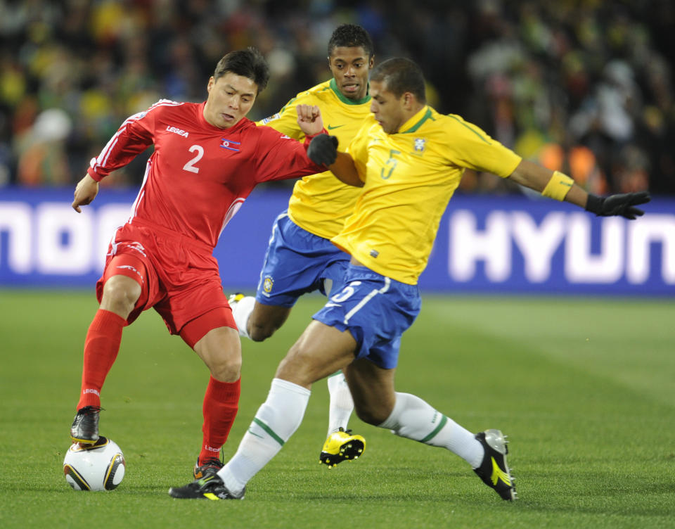 North Korea defender Cha Jong-hyeok (L) fights for the ball with Brazilian midfielder Felipe Melo during the first round of his Group G 2010 World Cup football match Brazil vs Brazil.  North Korea at the Ellis Park Stadium in Johannesburg on June 15, 2010.  No push for mobile / mobile use only within editorial article - AFP Photo / Pierre-Philippe Marco (photo credit should read Pierre-Philippe Marco / AFP via Getty Images)