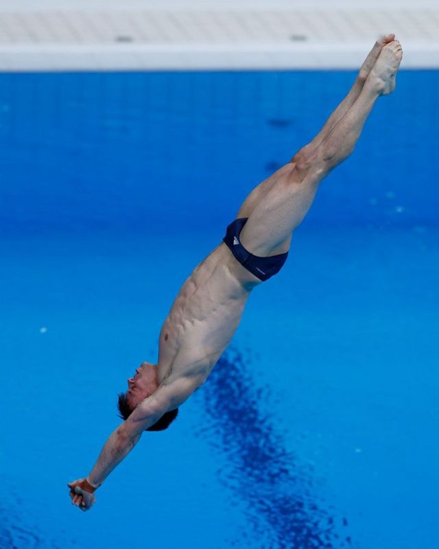 man jumping in swimming pool