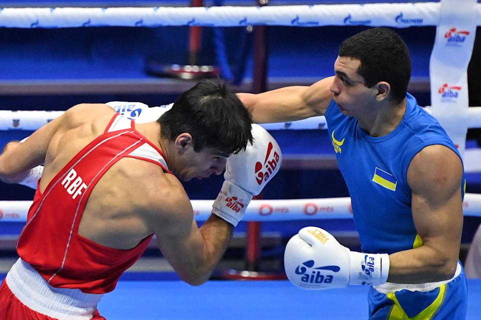 Vadim Musaev (red) of Russia fights against Yuri Zakharyev (blue) of Ukraine in the men's light middleweight during the AIBA Men's World Boxing Championship Final on November 6, 2021 in Belgrade.  (Photo by Andrej Isakovic/AFP via Getty Images)