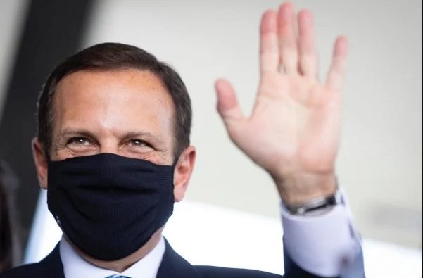 Joao Doria, Governor of Sao Paulo.  He wears a suit and tie and wears a mask - Metropolis