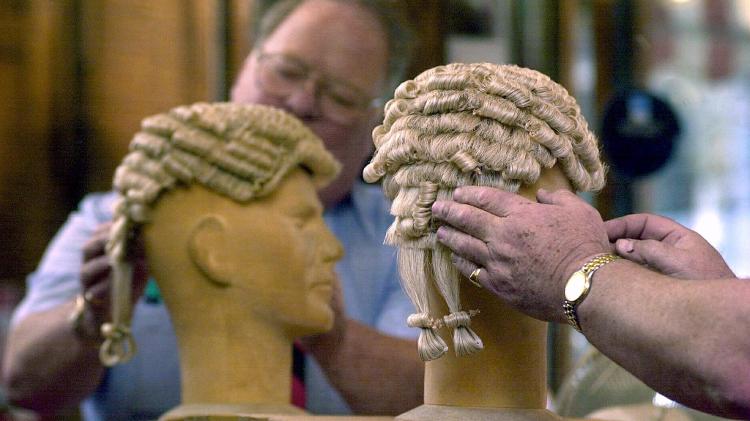 Why do British lawyers and judges wear wigs to court?
