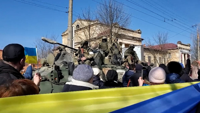 Pro-Ukraine activists in front of Russian soldiers during a demonstration in Kherson