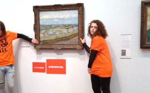 Climate activists in Britain shake hands on a Vincent van Gogh painting at the Museum of London