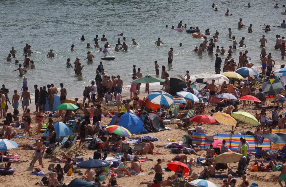 Adults and children enjoy the warm weather at Bournemouth Beach as the heat wave hits the country in Bournemouth (Photo: Reuters/Hannah McKay)